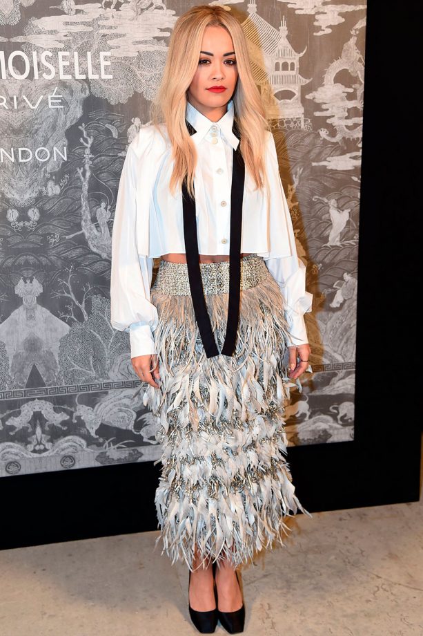 RIta Ora Wears A Metallic Feathered Skirt And Chanel Shirt To The Chanel Exhibition Party In London, 2015