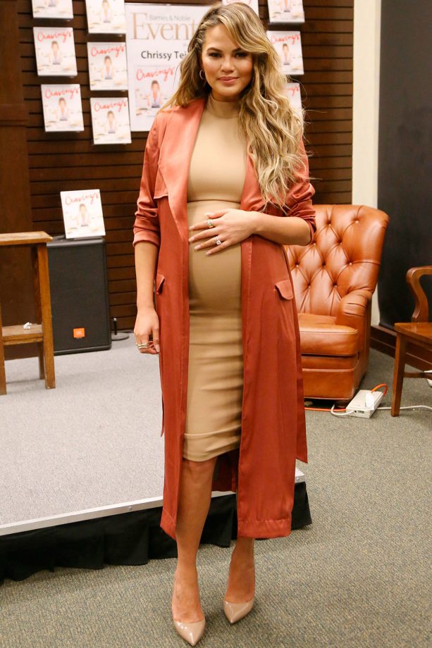 Chrissy Teigen Pairs A Fitted Midi Dress With A Silk Coat At Her Book Signing In LA, 2016