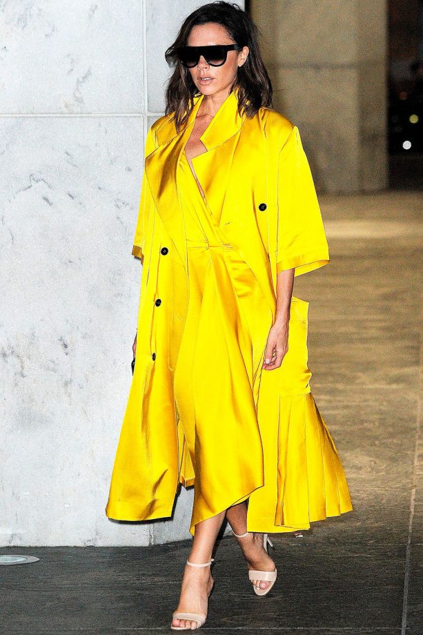 Victoria Beckham Injects Some Colour Into Her Look By Wearing A Yellow Wrap Dress And Matching Duster Coat Out And About In New York, 2016