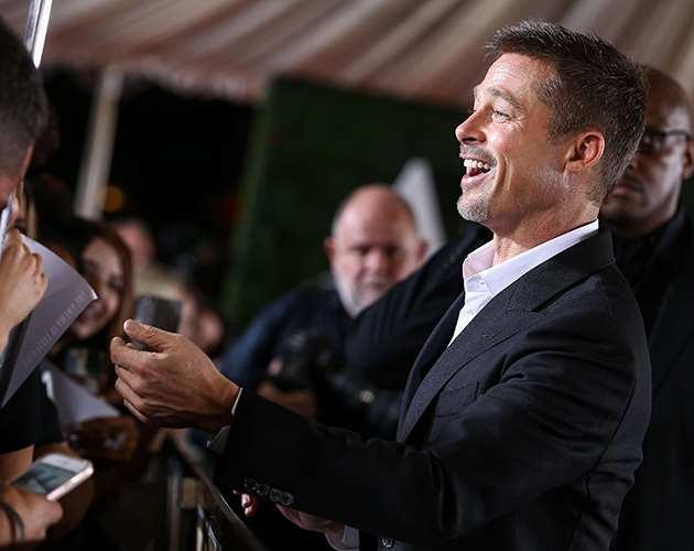 Brad Pitt was see laughing with fans as he signed autographs and posed for selfies...